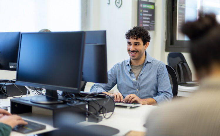 Professional in a modern office using vibe-coding tools to accelerate app development and build functional prototypes with AI.